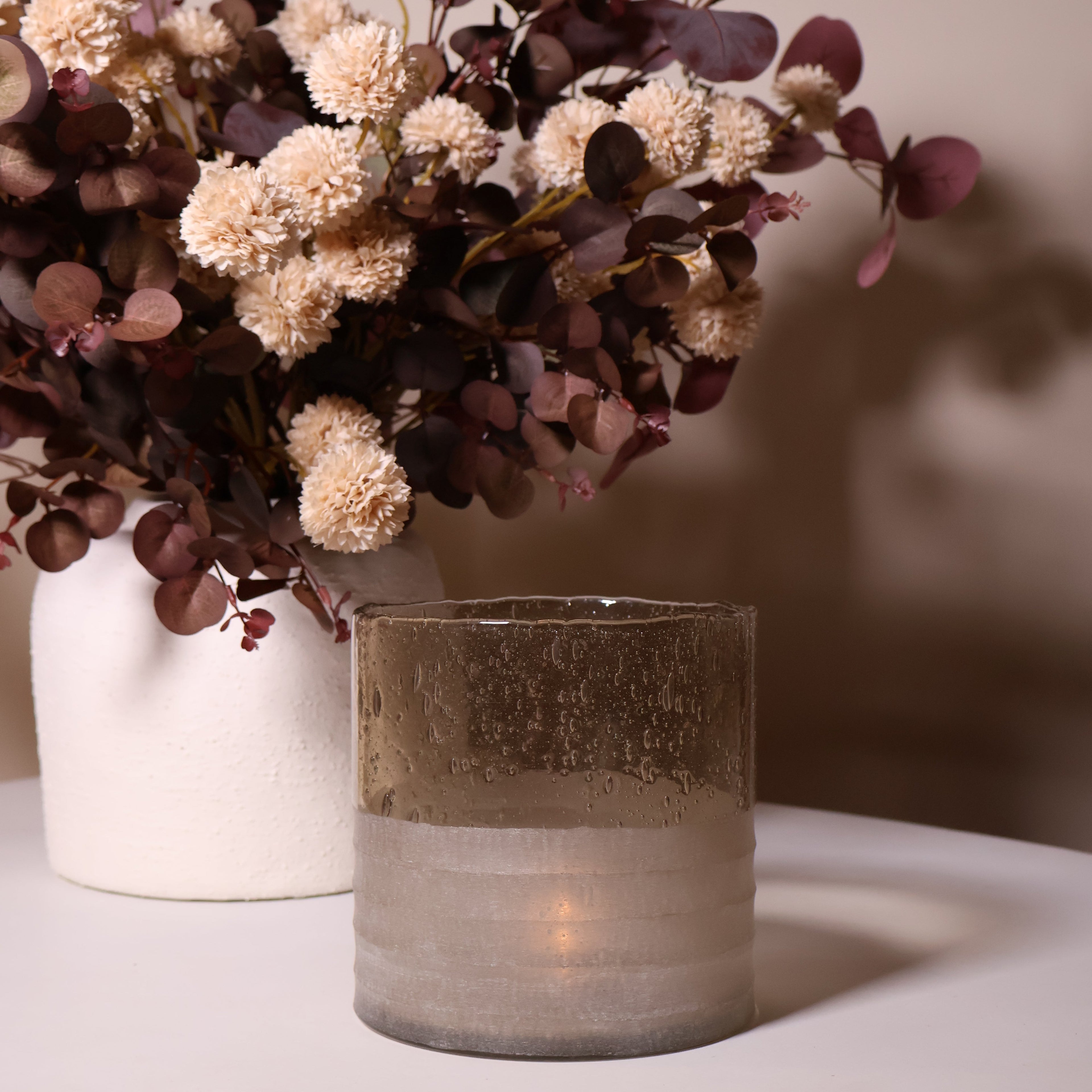 Glass Candle Holder paired with a vase and flowers on a coffee table